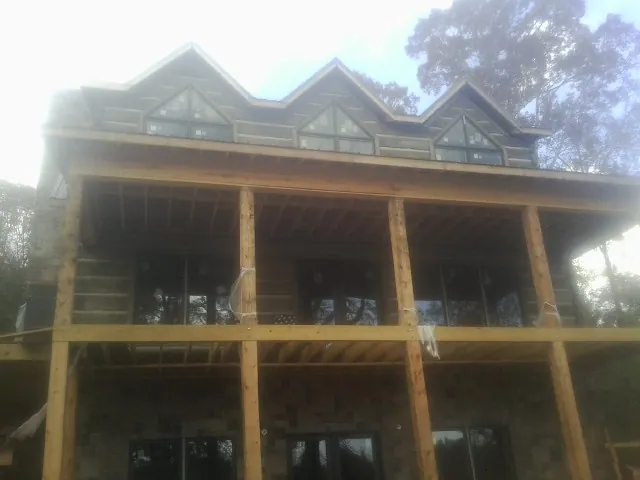 Dormers and porch framing on a large log home under construction in Anderson